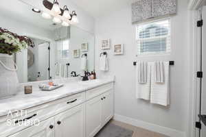 Bathroom with tile patterned flooring and vanity