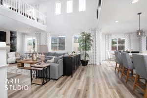 Living room featuring light wood-type flooring and a high ceiling