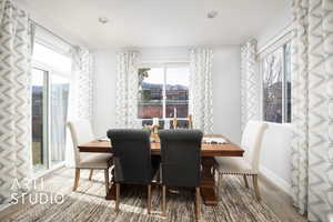 Dining space featuring wood-type flooring and plenty of natural light