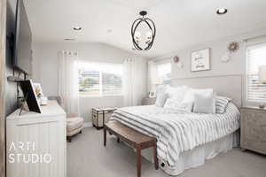 Bedroom with light carpet, an inviting chandelier, multiple windows, and lofted ceiling