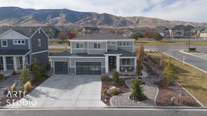 View of front of home featuring a mountain view and a garage