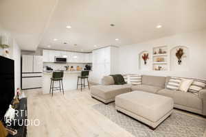 Living room with light hardwood / wood-style floors