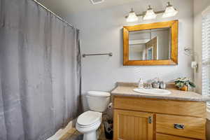 Bathroom featuring vanity and toilet