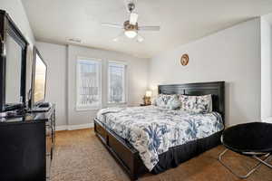 Bedroom with ceiling fan and carpet