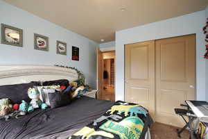 Bedroom with carpet flooring and a closet