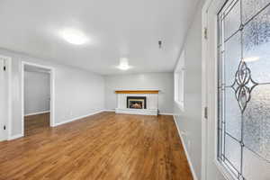 Unfurnished living room featuring a fireplace and wood-type flooring