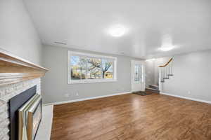 Unfurnished living room featuring a fireplace and wood-type flooring