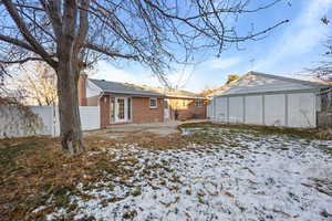 View of snow covered rear of property