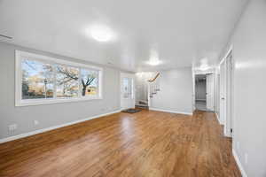 Unfurnished living room with hardwood / wood-style flooring