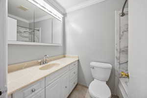 Bathroom featuring tile patterned floors, toilet, vanity, and ornamental molding