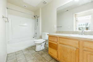 Full bathroom featuring vanity,  shower combination, and toilet