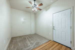 Unfurnished room with hardwood / wood-style flooring and ceiling fan