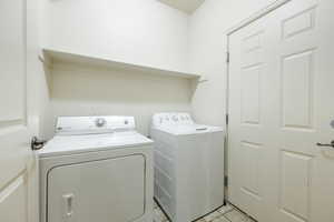 Washroom featuring washing machine and dryer