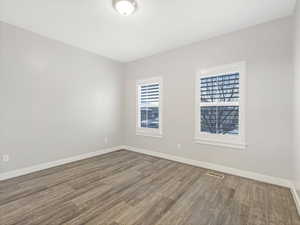 Unfurnished room featuring hardwood / wood-style flooring