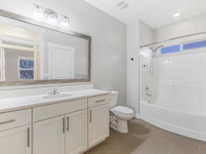 Full bathroom with vanity, toilet, and shower / washtub combination