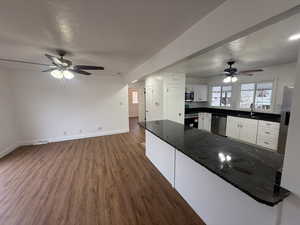 Kitchen featuring white cabinets, dark hardwood / wood-style flooring, stainless steel appliances, and sink