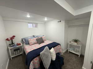 Bedroom featuring dark carpet