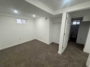 Basement with dark colored carpet