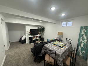 Bedroom featuring carpet and a textured ceiling