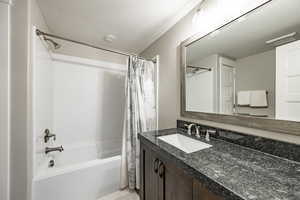 Bathroom featuring vanity and shower / bath combo with shower curtain