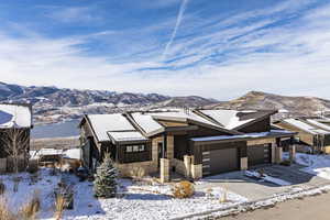 View of front facade with a mountain view and a garage