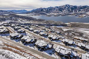 Snowy aerial view with a water and mountain view