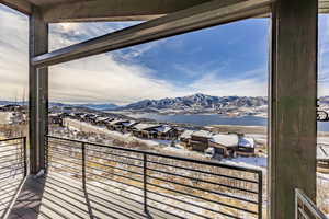 Snow covered back of property featuring a mountain view