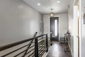 Foyer featuring dark wood-type flooring and an inviting chandelier