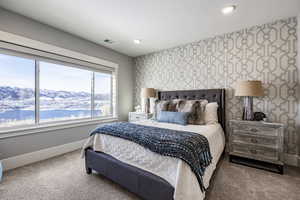 Bedroom with carpet and a water and mountain view