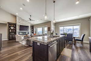 Kitchen featuring dark hardwood / wood-style floors, a kitchen island with sink, a healthy amount of sunlight, and sink