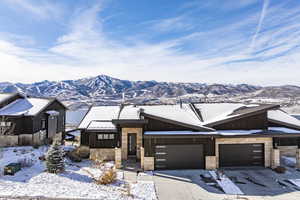 Single story home featuring a mountain view and a garage