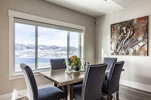 Dining area with a mountain view and dark wood-type flooring