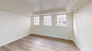 Spare room with hardwood / wood-style floors and a textured ceiling