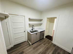 Kitchen featuring dishwasher, dark hardwood / wood-style floors, and sink