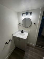 Bathroom featuring hardwood / wood-style flooring and vanity