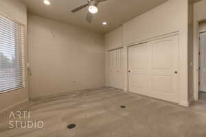 Bedroom with multiple closets, carpet, and ceiling fan and great views