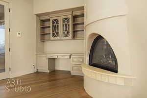 Custom built fireplace and built in desk and storage.