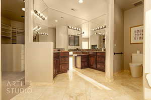 Bathroom with vanity,beautiful floors and cabinetry.