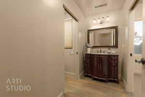 Bathroom featuring wood flooring and vanity