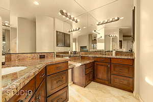 Bathroom vanities with custom counters and cabinetry.