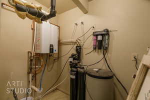 Utility room with tankless water heater, filtration system and water softener.