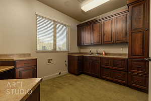 Laudry room with tons of storage, a sink and lots of countertop space.