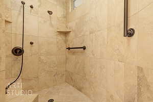 Custom tiled shower with grab bars.