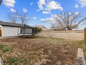 View of yard with a trampoline