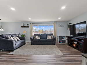 Living room featuring dark wood-type flooring and a wealth of natural light