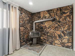 Interior details with a wood stove and a textured ceiling