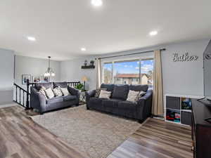 Living room with a chandelier and hardwood / wood-style floors