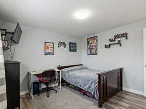 Bedroom with hardwood / wood-style floors