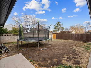 View of yard featuring a trampoline