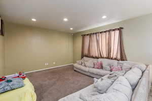 Living room featuring carpet and a textured ceiling